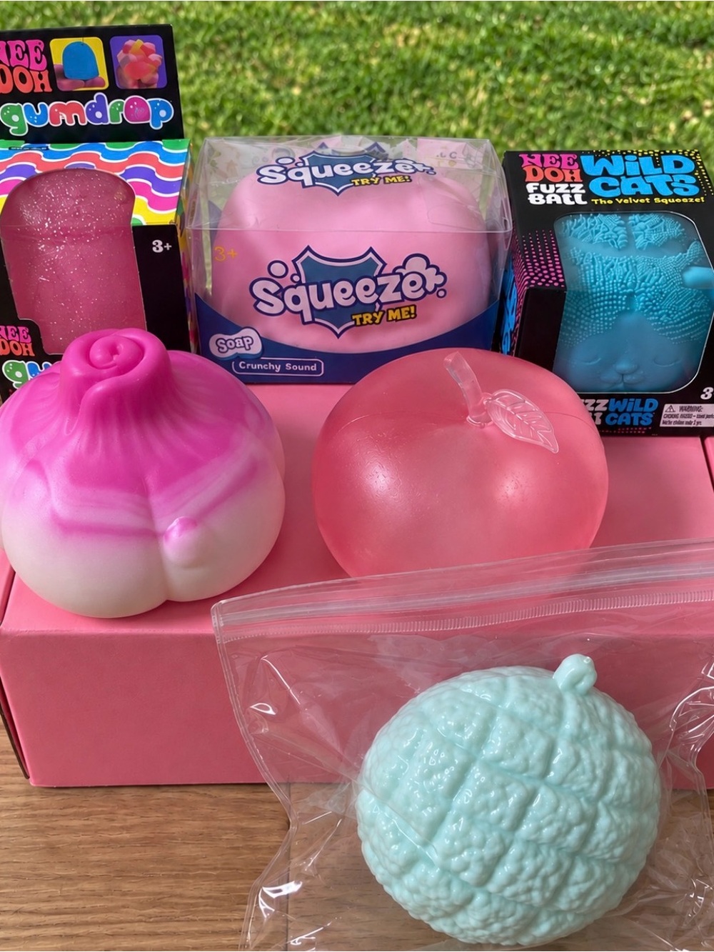 NeeDoh Wildcat, Gumdrop. pink squishy items shown. CrunchyX2. Apple moldable.